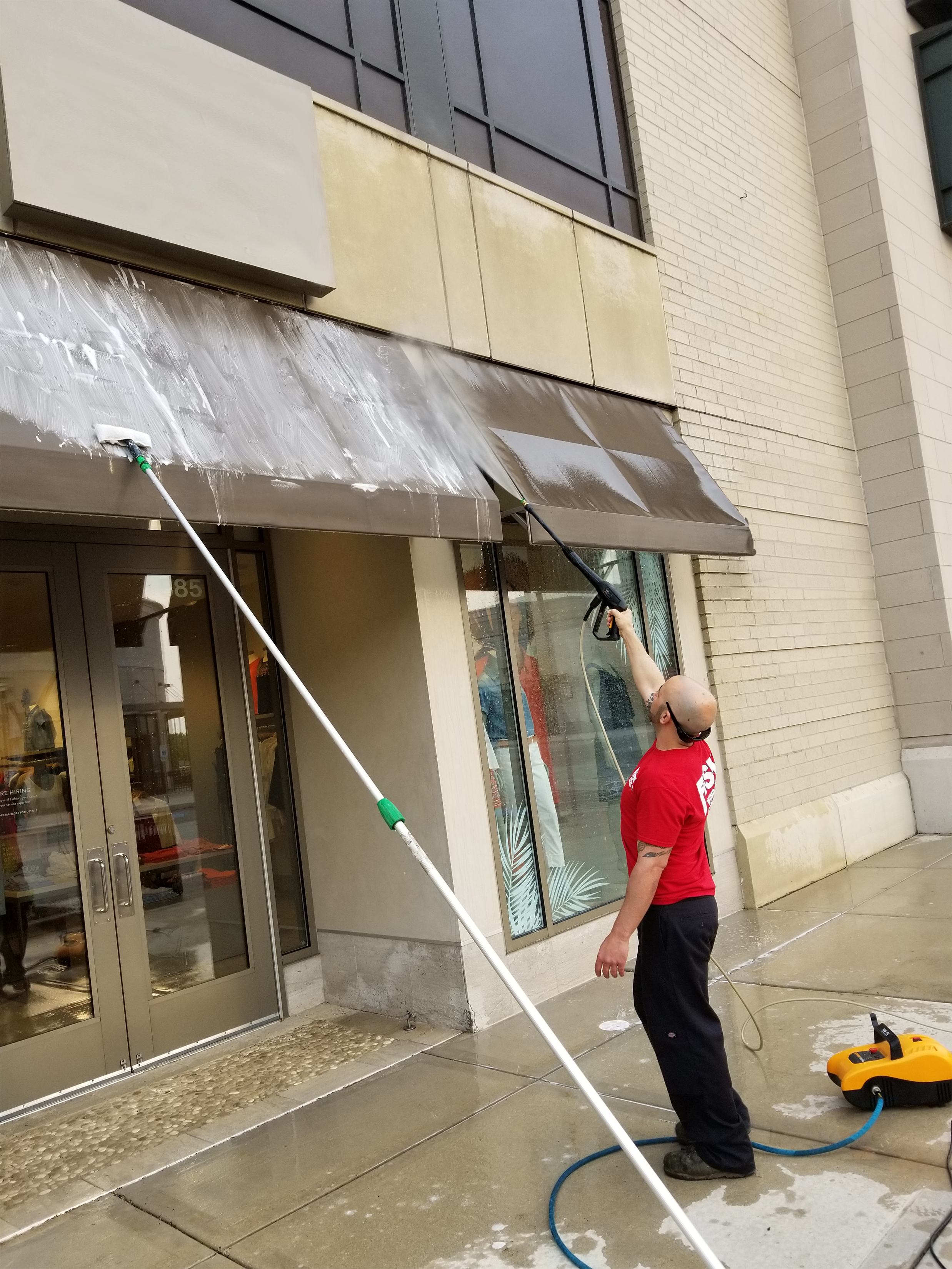 Image of Fish Window Cleaner Cleaning Storefront Awnings